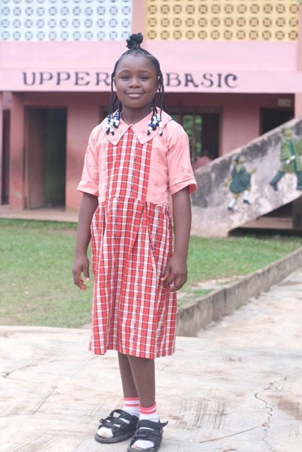 Student in front of school building